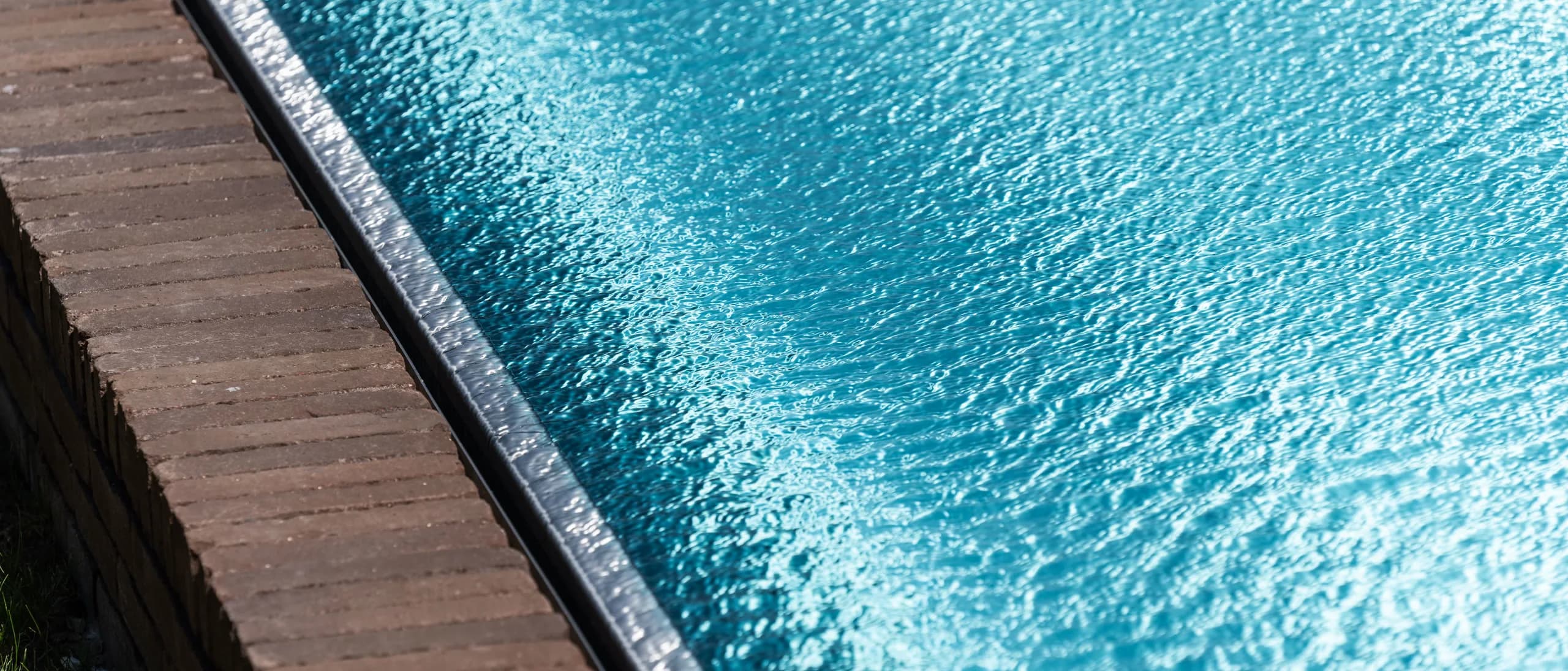 Crystal clear turquoise pool water in bright sunlight